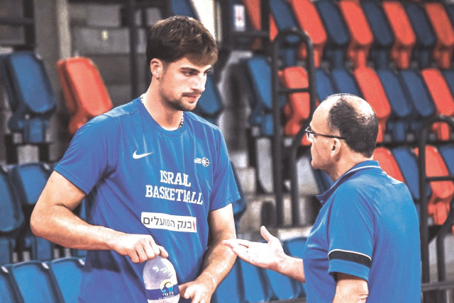  DENI AVDIJA (left) talks with Israel head coach Ariel Beit Halachmi this week during the opening practice for the National Team at Tel Aviv’s Drive-In Arena. (credit: YEHUDA HALICKMAN)