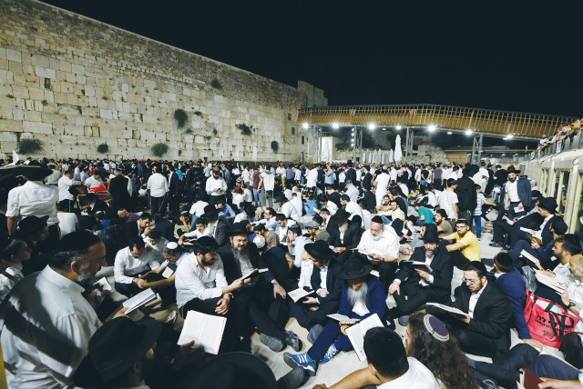  WORSHIPERS SIT on the ground as a sign of mourning on Tisha Be’av last year at the Western Wall (credit: OLIVIER FITOUSSI/FLASH90)