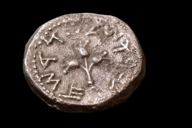  The silver coin, as found, showing the obverse face with the chalice in the center, and above it the letter “Aleph” marking Year 1 of the outbreak of the  revolt, and the inscription “half-shekel”, the value of the coin. (credit: Emil Aladjem, Israel Antiquities Authority)