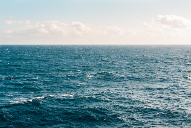  The calm dark blue surface of the ocean on a clear day. (credit: PEXELS)