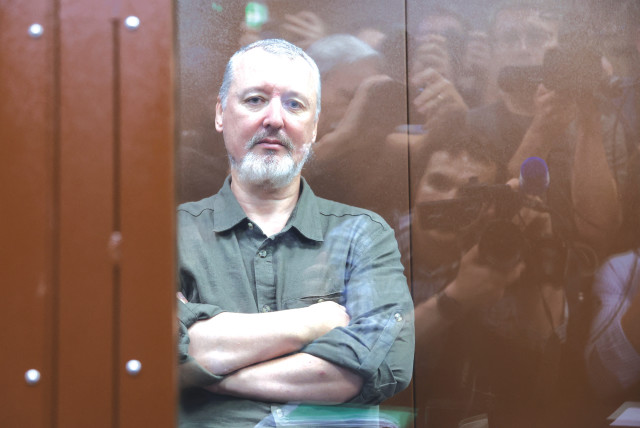  IGOR GIRKIN, charged with inciting extremist activity, sits behind a glass wall of an enclosure for defendants, before a court hearing in Moscow. (credit: REUTERS/Yulia Morozova)