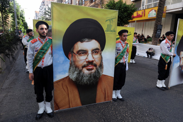 Members of Imam al-Mahdi scouts carry a picture of Lebanon's Hezbollah leader Sayyed Hassan Nasrallah, during a religious procession to mark Ashura in Beirut’s southern suburbs, Lebanon July 29, 2023 (credit: REUTERS/AZIZ TAHER)