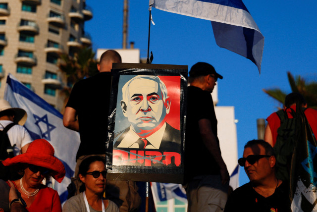  A placard depicting Israeli Prime Minister Benjamin Netanyahu is seen as people demonstrate on the 'Day of National Resistance' in protest against him and his nationalist coalition government's judicial overhaul, near U.S. Consulate in Tel Aviv, Israel July 18, 2023 (credit: REUTERS/AMMAR AWAD)