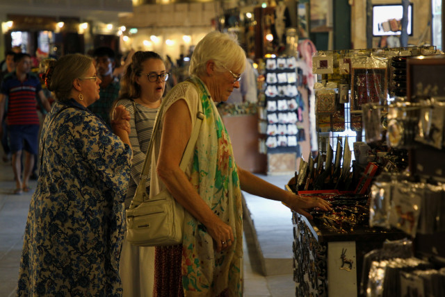  Foreign tourists shop at Souq Waqif in Doha, Qatar, October 20, 2019. (credit: NASEEM ZEITOON/REUTERS)
