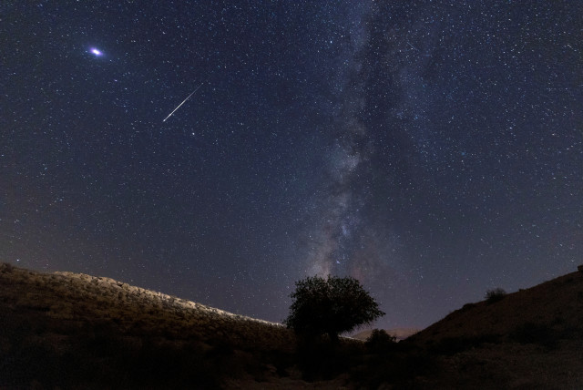 A meteor streaks past stars in the night sky during the annual Perseid meteor shower at the Negev Desert in southern Israel, August 13, 2021. (credit: AMIR COHEN/REUTERS)