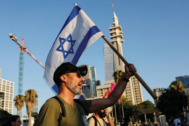  A protester shouts slogans near the Defence Ministry as IDF reservists sign a pledge to suspend voluntary military service if the government passes judicial overhaul legislation in Tel Aviv, July 19. (credit: AMIR COHEN/REUTERS)