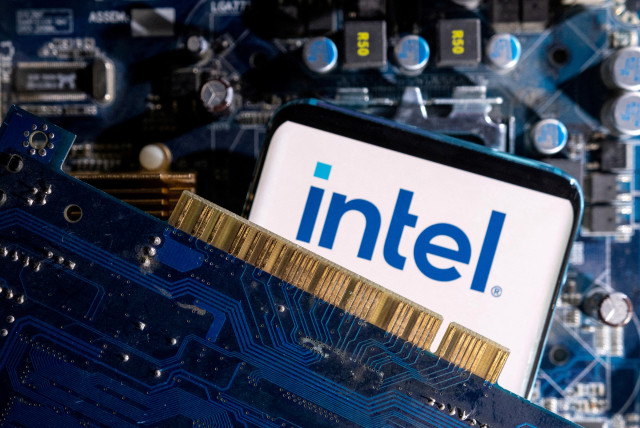   A smartphone with a displayed Intel logo is placed on a computer motherboard in this illustration taken March 6, 2023.  (credit: REUTERS/DADO RUVIC/ILLUSTRATION/FILE PHOTO)