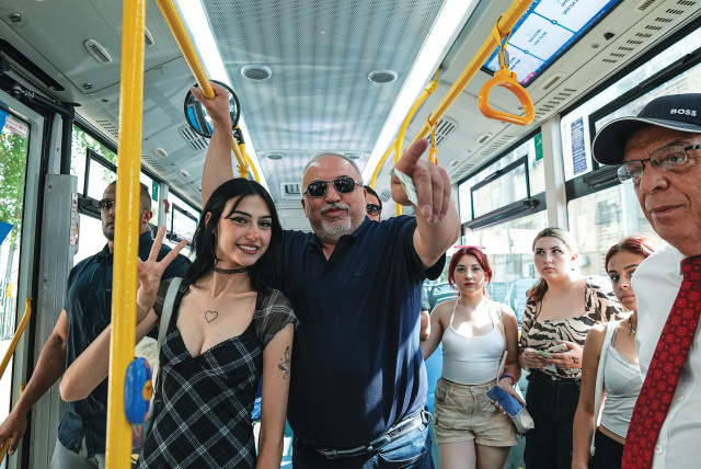  YISRAEL BEYTENU chairman MK Avigdor Liberman rides on a bus in Ashdod on Wednesday, after a recent incident of gender discrimination on a city bus. (credit: FLASH90)