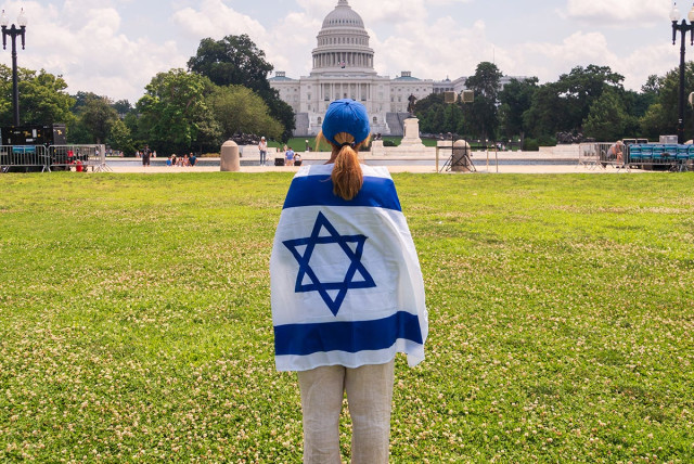  A young woman wearing an Israeli flag. (credit: MELANIE PHILLIPS)