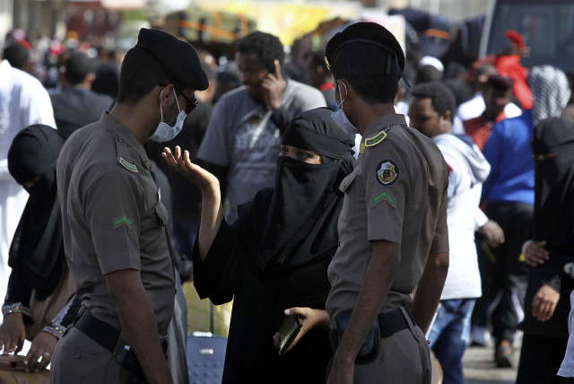  An Ethiopian worker argues with the Saudi security forces while waiting for repatriation in Manfouha (credit: REUTERS)