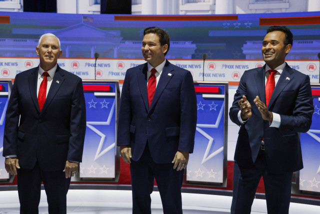 Former U.S. Vice President Mike Pence, Florida Governor Ron DeSantis and businessman Vivek Ramaswamy pose together before the start before the start of the first Republican candidates' debate of the 2024 U.S. presidential campaign in Milwaukee, Wisconsin, U.S. August 23, 2023 (credit: REUTERS/JONATHAN ERNST)