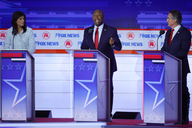  US Senator Tim Scott (R-SC) speaks as former South Carolina Governor Nikki Haley and North Dakota Governor Doug Burgum listen at the first Republican candidates' debate of the 2024 US presidential campaign in Milwaukee, Wisconsin, US August 23, 2023 (credit: REUTERS/BRIAN SNYDER)