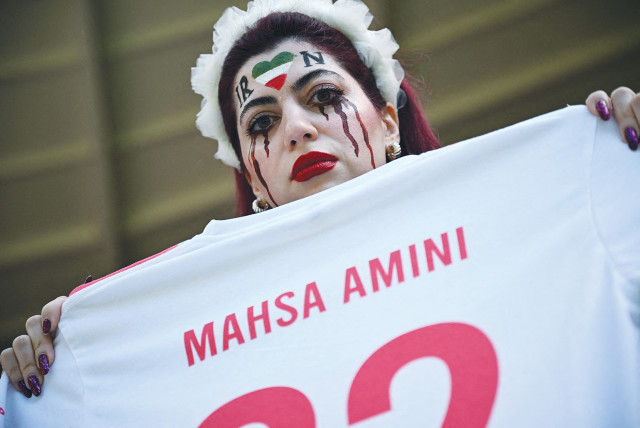  AN IRANIAN fan holds a jersey in memory of Mahsa Amini, inside the stadium before a World Cup soccer match between Iran and Wales, in Qatar, last November. 