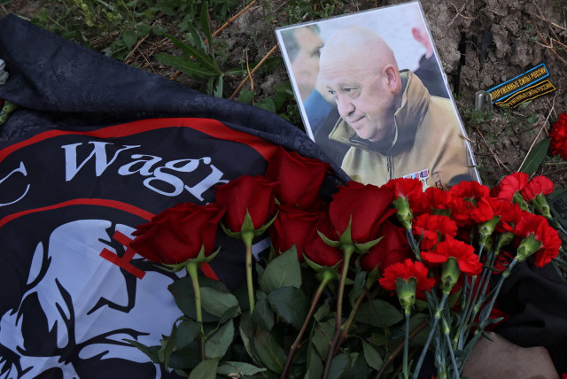  A view shows a portrait of Wagner mercenary chief Yevgeny Prigozhin at a makeshift memorial near former PMC Wagner Centre in Saint Petersburg, Russia August 24, 2023.  (credit:  REUTERS/Anastasia Barashkova)