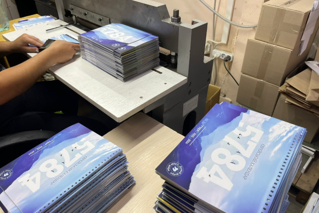  Booklets are seen being made for Ukrainian Jews ahead of the High Holy Days. (credit: FJCU)