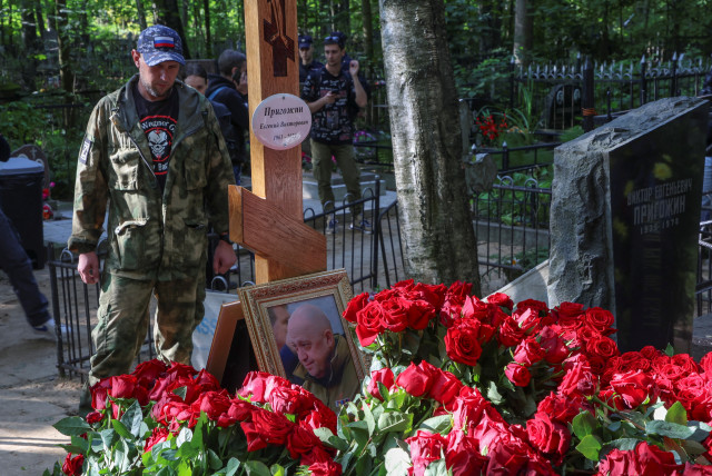  A man wearing a shirt with the logo of Wagner private mercenary group stands next to the grave of Russian mercenary chief Yevgeny Prigozhin at the Porokhovskoye cemetery in Saint Petersburg, Russia, August 30, 2023.  (credit: REUTERS/STRINGER)