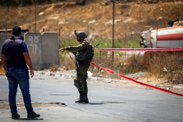  Police and rescue forces at the scene of a car ramming terror attack near Hebron, in the West Bank, August 30, 2023.  (credit: WISAM HASHLAMOUN/FLASH90)