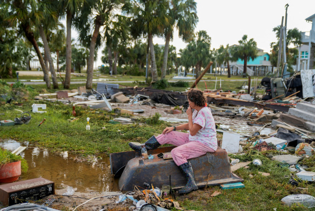 Jewell Baggett, 51, sits on a bathtub amid the wreckage of the home built by her grandfather, where she grew up and three generations of her family lived, and which Hurricane Idalia had reduced to rubble, in Horseshoe Beach, Florida, U.S., August 30, 2023. (credit: REUTERS/Cheney Orr)