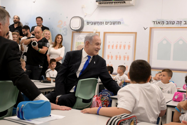 Prime Minister Benjamin Netanyahu visits an Israeli primary school on the first day of school on September 1, 2023 (credit: Avi Ohayon/GPO)