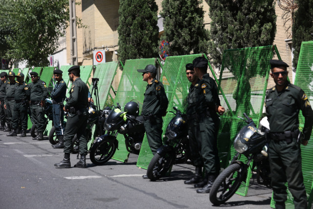 Police stand guard outside the Swedish Embassy during a protest against a man who burned a copy of the Quran outside a mosque in the Swedish capital Stockholm, in Tehran, Iran June 30, 2023.  (credit: MAJID ASGARIPOUR/WANA/REUTERS)