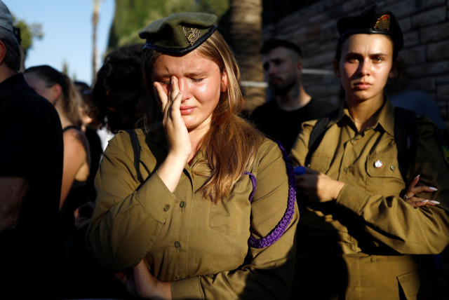  People mourn Maksym Molchanov, an Israeli soldier who moved to Israel from Ukraine and was killed in a ramming attack adjacent to the Maccabim Checkpoint, at his funeral in Tel Aviv, Israel September 5, 2023 (credit: REUTERS)