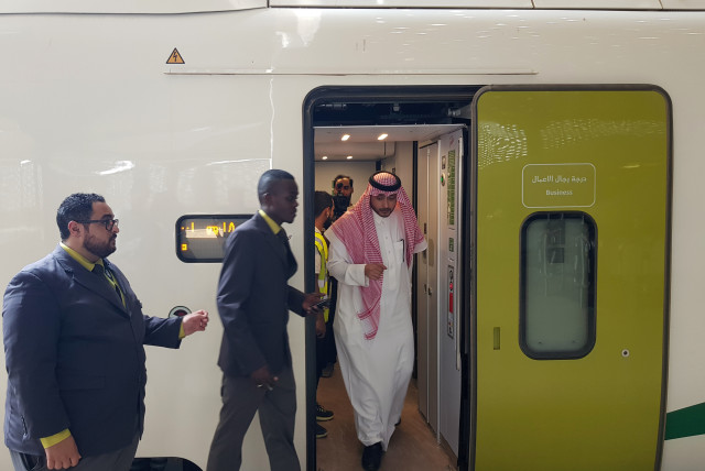  Saudi people board at the new KAEC station of the Haramain speed train at King Abdullah Economic City, near Jeddah, Saudi Arabia (credit: REUTERS/STEPHEN KALIN)