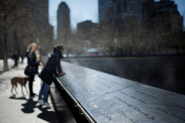 People visit the 9/11 Memorial, in New York City, US, March 21, 2023. (credit: REUTERS/AMANDA PEROBELLI)