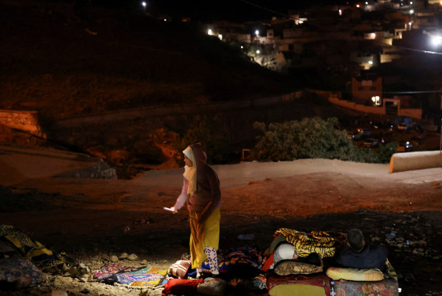  Residents rest on the street in Moulay Brahim village, in the province of Al Haouz, following a powerful earthquake in Morocco, September 9, 2023. (credit: REUTERS/NACHO DOCE)