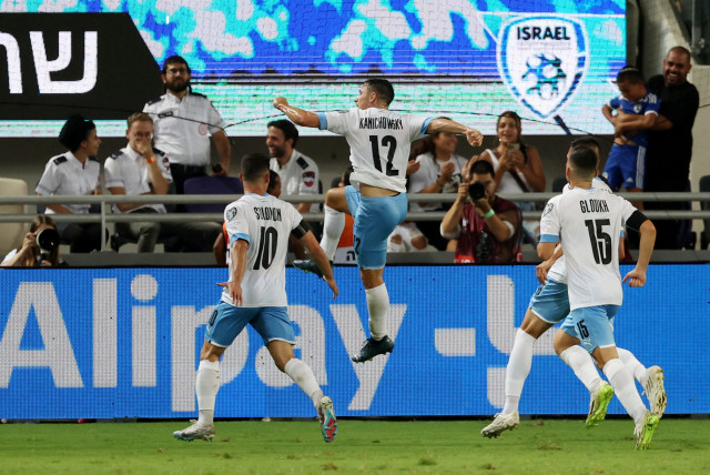  GABY KANICHOWSKY (jumping in air) celebrates with his Israel teammates after scoring in stoppage time late Tuesday night to give the blue-and-white a 1-0 victory over visiting Belarus at Bloomfield Stadium in their Group I Euro 2024 qualifier. (photo credit: RONEN ZVULUN/REUTERS)