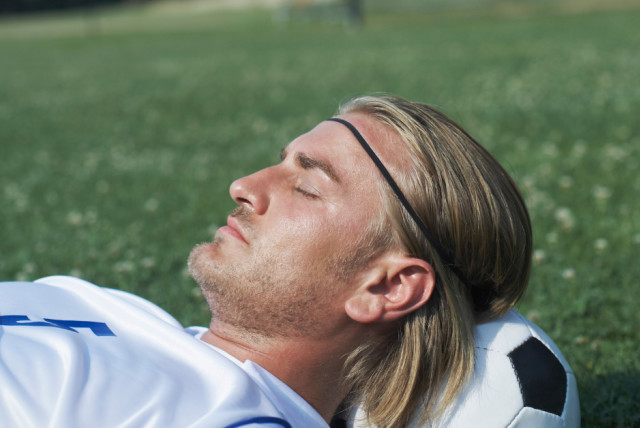  Surprisingly, neither his teammates nor the team's staff noticed the absence of their captain. Soccer player sleeping (illustration) (photo credit: THINKSTOCK)