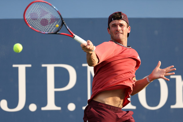  AT THE US Open: Tommy Paul (US) returns a shot against Roman Safiullin (Russia) during their Men’s Singles Second Round match, in Queens, New York, Aug. 30.  (credit: Matthew Stockman/Getty Images)