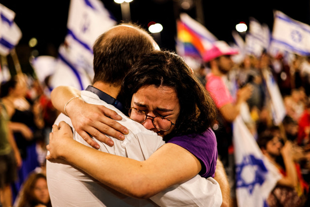  PROTESTERS HUG during an anti-judicial reform protest near the Knesset, in July.  (photo credit: AMIR COHEN/THE JERUSALEM POST)
