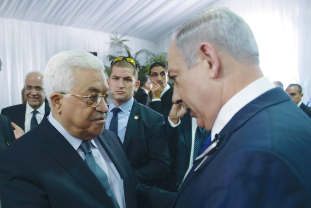  PRIME MINISTER Benjamin Netanyahu shakes hands with PA head Mahmoud Abbas at the funeral of Shimon Peres, in Jerusalem, 2016. The Oslo process has been continued by every government including by Benjamin Netanyahu, says the writer.  (credit: AMOS BEN-GERSHOM/GPO)