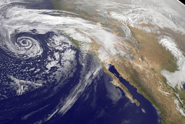 A swirling Eastern Pacific Ocean storm system headed for California is seen in an image from NOAA's GOES-West satellite taken at 0930 EST (1430 GMT) February 28, 2014. According (photo credit: REUTERS/NASA/NOAA/Handout)
