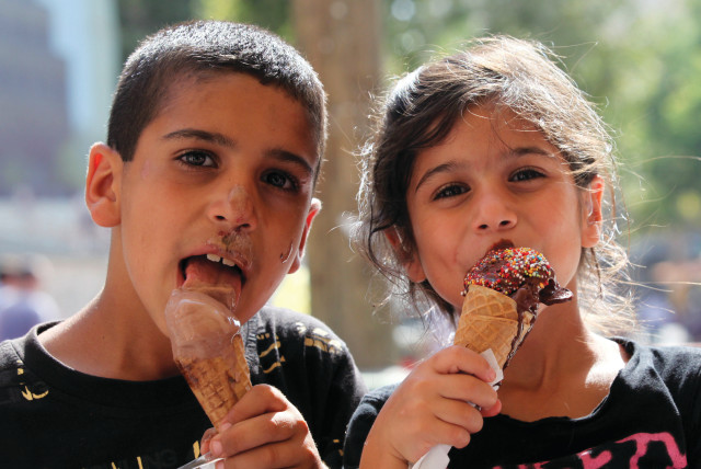  CHILDREN ENJOY ice cream cones. Parents have been told by the Education Ministry that they must not give milk; yellow cheese; cottage cheese; peanut snacks like Bamba or peanut butter; and many more staples to their children to bring to school. (photo credit: YOSSI ZAMIR/FLASH90)