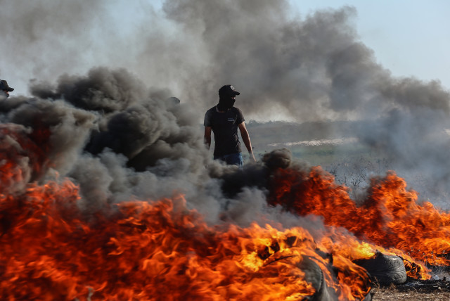  Palestinian protesters gather during a demonstration along the border fence with Israel, east of Gaza City, on September 18, 2023. (photo credit: ATIA MOHAMMED/FLASH90)