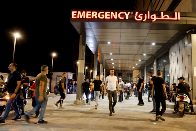 People stand outside a hospital, during an Israeli raid in Jenin, in the West Bank, September 19, 2023. (credit: RANEEN SAWAFTA/REUTERS)