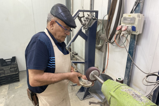  Shimon Keinan sanding a shofar in his workshop at Kol Shofar, Moshav Ramat Yoav, Israel. (credit: Aaron Poris/The Media Line)