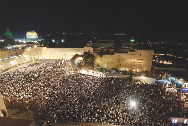  THE MASSES gather at the Western Wall to recite prayers for forgiveness before Yom Kippur, as viewed from the Aish World Center rooftop, this past Saturday night. (photo credit: MARC ISRAEL SELLEM/THE JERUSALEM POST)