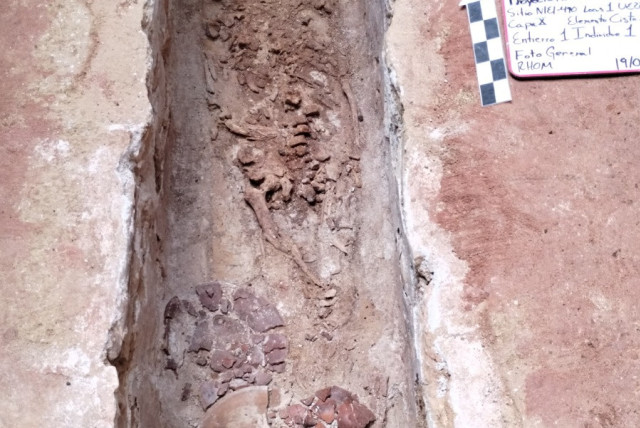 The remains of a human burial, unearthed by Mexican archaeologists during salvage work carried out in Palenque in tandem with building the rail project known as the Maya Train, are seen in this undated Handout photo received from Mexico's National Institute of Anthropology and History (INAH) on Sept (credit: INAH/Handout via REUTERS)