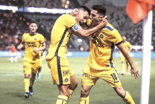  MACCABI TEL AVIV teammates Eran Zahavi (left) and Dan Bitton celebrate a goal in the yellow-and-blue’s 5-0 derby victory over Hapoel Tel Aviv at Bloomfield Stadium. (credit: MACCABI TEL AVIV/COURTESY)