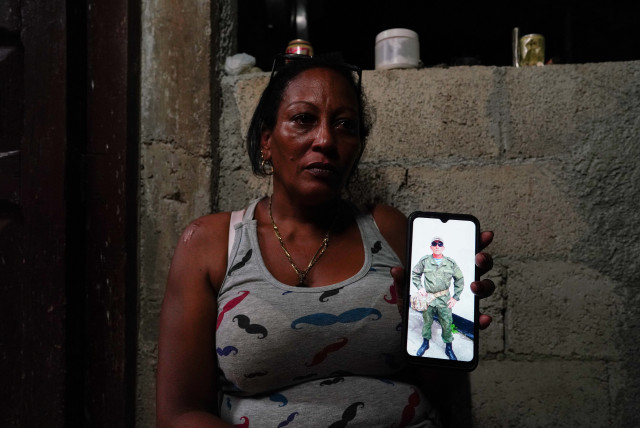  Yamidely Cervantes, 42, shows an undated photo of her husband Enrique Gonzalez, 49, dressed in military uniform in a bootcamp in Russia, La Federal, Cuba, September 19, 2023 (credit: REUTERS)