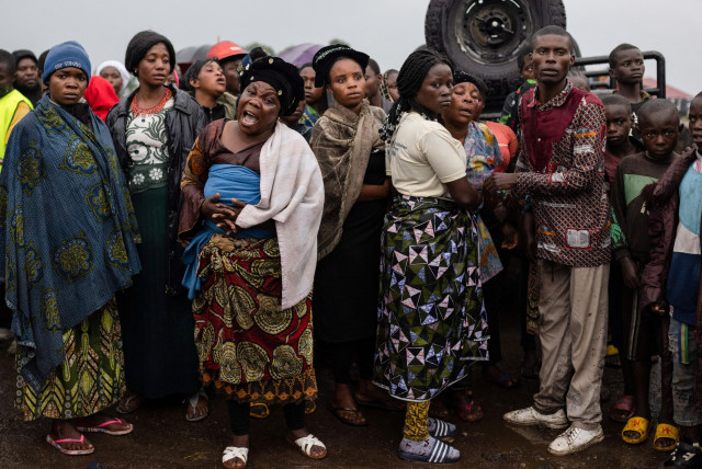  Relatives react as the coffin of a protestor killed during a demonstration is carried before burial at the Makao cemetery in Goma, North Kivu province, Democratic Republic of the Congo September 18, 2023. (credit: REUTERS/Arlette Bashizi)