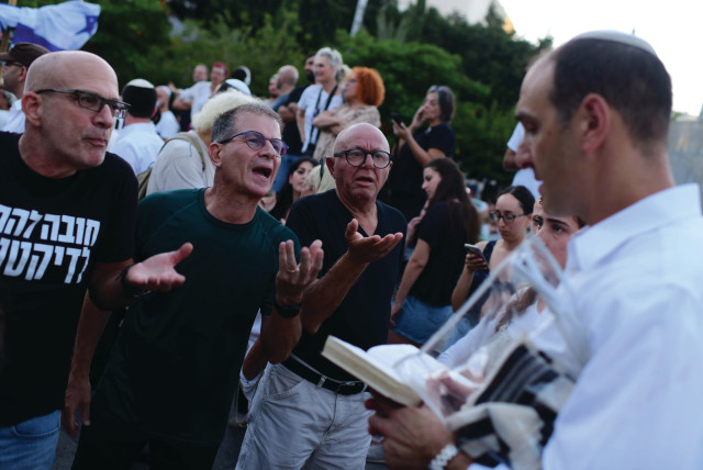  PROTESTERS CONFRONT a worshiper at Dizengoff Square in Tel Aviv, at the onset of Yom Kippur, last week (credit: TOMER NEUBERG/FLASH90)
