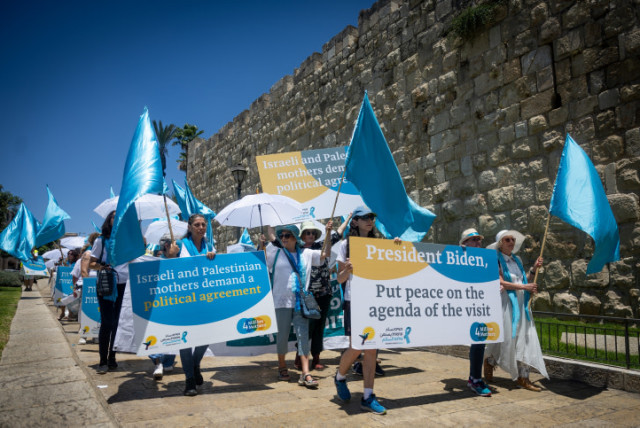  Women from the 'Women Wage Peace' movement take part at a protest in support of peace, near the Old City walls in Jerusalem, on July 14, 2022 (credit: YONATAN SINDEL/FLASH90)
