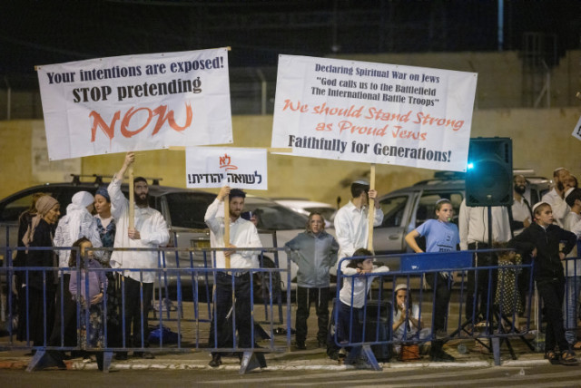 Orthodox Jews hold signs reading ''Out with the Christians, Jews-Don't Enter'' during a protest outside the Christian Feast of Tabernacles event where Israeli minister of Intelligence Gila Gamliel spoke, October 3, 2023 (credit: CHAIM GOLDBEG/FLASH90)