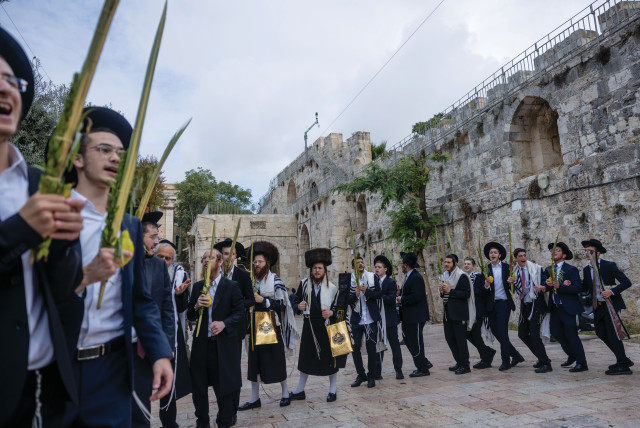  SINGING AND dancing in honor of Sukkot at the entrance to the Temple Mount compound, in Jerusalem’s Old City, Oct. 1.  (credit: Chaim Goldberg/Flash90)