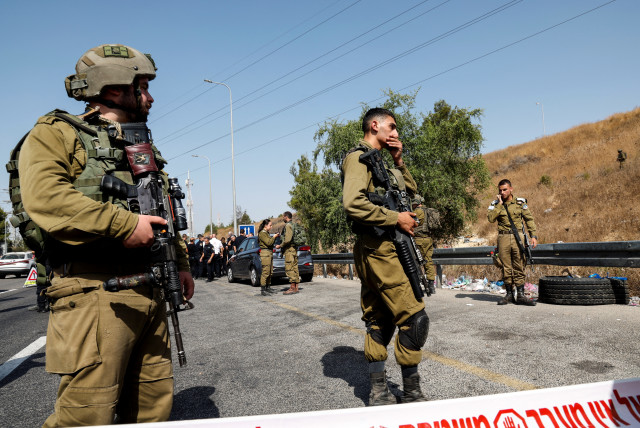  Israeli soldiers attend the scene at which, according to Israeli police, a truck driver hit several pedestrians before being neutralised at Maccabim checkpoint in the West Bank August 31, 2023. (credit: REUTERS/AMMAR AWAD)