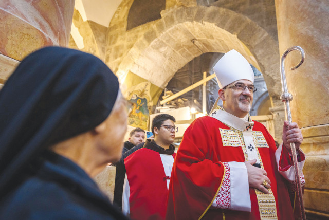 MEMBERS OF the clergy and the local Catholic community attend a mass for the late Pope Emeritus Benedict XVI, led by the Latin Patriarch Pierbattista Pizzaballa at the Church of the Holy Sepulchre, in Jerusalem’s Old City in January.  (credit: OLIVIER FITOUSSI/FLASH90)