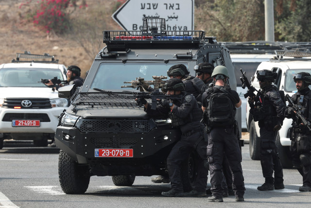  Israeli security stand in position on a road following a mass infiltration by Hamas gunmen from the Gaza Strip, near Sderot in southern Israel October 8, 2023. (credit: RONEN ZVULUN/REUTERS)
